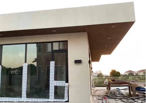 Hengyuan WPC wall panels applied to the exterior eaves and corridor ceilings of modern architecture, showcasing superior flatness and refined texture.
